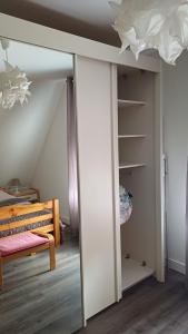 a bedroom with a bed and a door to a closet at petite chambre sympathique in Hurtigheim