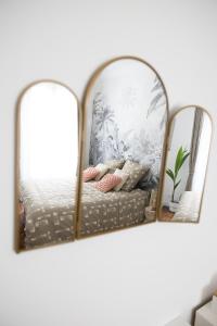 a mirror sitting on a shelf next to a bed at Eiffel Playcation in Paris