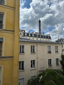 a view of a building with a tower in the background at Eiffel Playcation in Paris