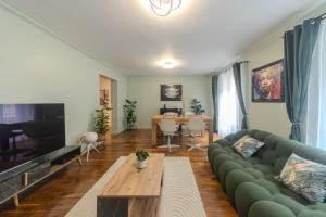 a living room with a couch and a table at Eiffel Playcation in Paris