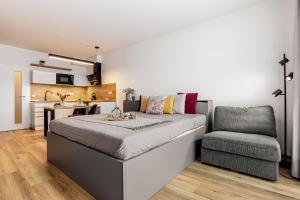 a bedroom with a bed and a chair at KORZO Couple in Lipno nad Vltavou