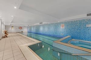 a large swimming pool in a building at Comfy Studio Next to Chatswood Station in Sydney