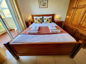 a bedroom with a large bed with two pillows at Quarteira Central 2 by Homing in Quarteira