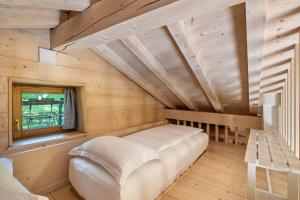 Zimmer in einem Blockhaus mit einem Bett in der Unterkunft Wunderchalet in Daone