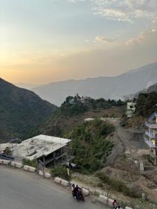 a couple of people on a motorcycle on a hill at Uk09 hotel & Restaurant in Mussoorie