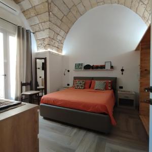 a bedroom with a bed and a stone ceiling at La Casecchia in Porto Cesareo