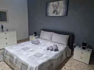 a bedroom with a bed with two pairs of shoes on it at B&B da Giovy in Marsala