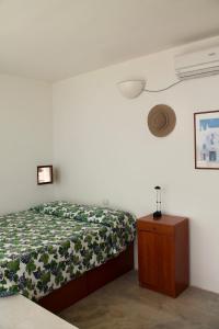 a bedroom with a bed and a wooden dresser at Capitolo in Monopoli