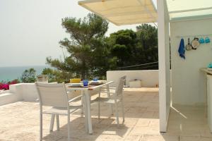 a white table and chairs on a patio at Capitolo in Monopoli
