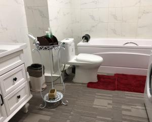 a bathroom with a toilet and a tub and a sink at Eagle Town Serviced Apartment- Free Pick up from Airport in Ulaanbaatar