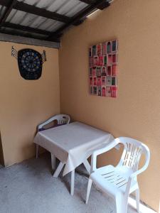 a table and two white chairs in a room at Kuća za odmor Majka in Fojnica +25 photos