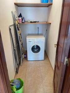 a small laundry room with a washing machine in it at O CAMIÑO Da IGLESIA in Muxia