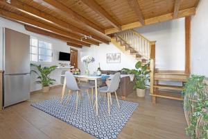 a kitchen and dining room with a table and chairs at Casa Evarista in Icod de los Vinos +21 photos