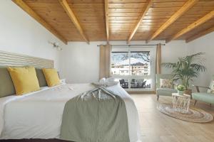 a bedroom with a large bed and a large window at Casa Evarista in Icod de los Vinos