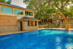 a swimming pool in front of a house at Lotus by Serendib in Blantyre