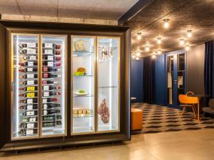 a display case filled with lots of wine bottles at Mercure Bordeaux Centre Ville in Bordeaux