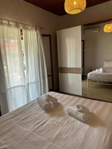 En eller flere senge i et værelse på Bougainvillea House