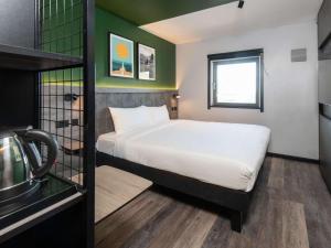 mały pokój z łóżkiem i oknem w obiekcie ibis Styles London Gatwick Airport w mieście Crawley