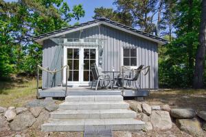 a small shed with a table and chairs in it at Chalet Ostsee Haus Nr. 72 in Göhren