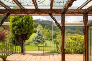 a conservatory with a view of a tree at Hotel & Spa Etxegana in Zeanuri