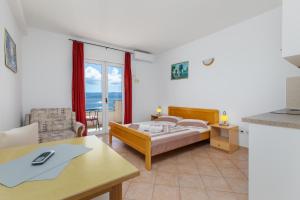Postel nebo postele na pokoji v ubytování Sita Apartmani