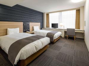 Tempat tidur dalam kamar di Comfort Hotel Hakata