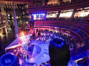 a crowd of people sitting in an auditorium at a concert at Comfort Hotel Hakata in Fukuoka