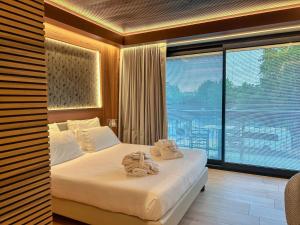 a bedroom with a bed with towels on it at Alevic Hotel Sirmione in Sirmione