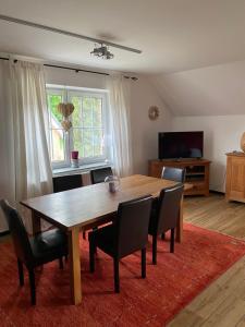 a dining room with a wooden table and chairs at Ferienhof Kröger in Bielefeld