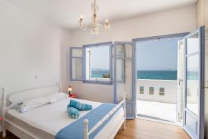 a bedroom with a bed with a view of the ocean at Orkos View House in Plaka