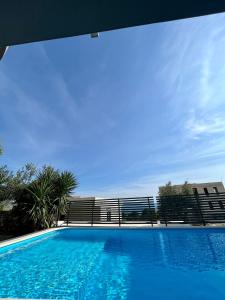 une grande piscine d'eau bleue en face d'un bâtiment dans l'établissement Villa Collis, à Makarska