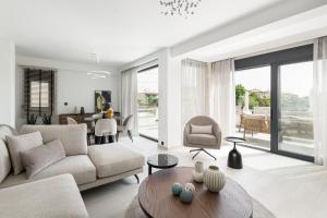 a living room with a couch and a table at Black Lotus Pool Villa, Afitos #FeelsLikeHome in Afitos