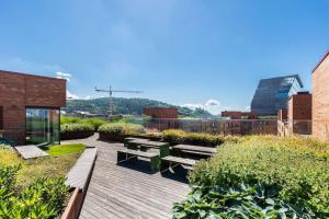 a wooden deck with benches on top of a building at Superb apartment by Opera house in Oslo