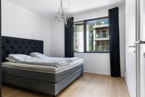 a bedroom with a bed and a window at Superb apartment by Opera house in Oslo