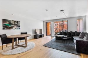a living room with a couch and a table at Superb apartment by Opera house in Oslo