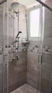 a shower with a glass door in a bathroom at Maistrali Hotel & Restaurant in Kalavárda