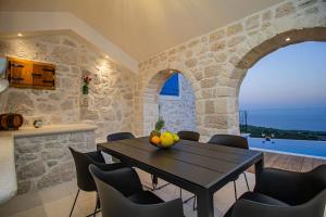 a kitchen and dining room with a table and chairs at Incredibly beautiful Stone House Villa Lota - Makarska Exklusiv in Bast