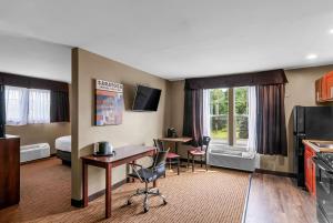ein Hotelzimmer mit einem Schreibtisch und einem Bett sowie einer Küche in der Unterkunft The Hotel Saratoga, Ascend Hotel Collection in Saratoga Springs