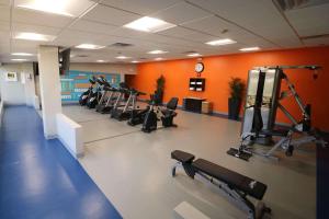 a gym with a row of treadmills and machines at Radisson Hotel Southfield-Detroit in Southfield