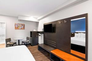 a hotel room with a bed and a bed and a room at Econo Lodge Bethel - Danbury in Bethel