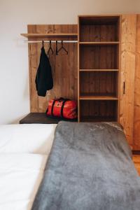 a bedroom with a bed and a book shelf at Rosa Alpina Appartement in Bürserberg