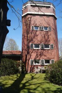 a tall brick building with four windows on it at Ferienhaus Turm360, FeWo Vermittlung Nordsee, C Hüppeler in Varel