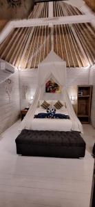 a bed with a canopy in a room at The Lucky Cottage in Nusa Lembongan
