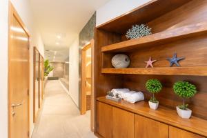a hallway with a wooden wall with shelves and plants at Hotel LIVVO Puerto de Mogán in Puerto de Mogán