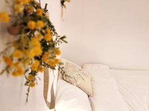 a vase filled with yellow flowers next to a couch at MoonStay in Seoul