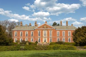 a large brick building with chimneys on top of it at Bosworth Hall Hotel & Spa in Market Bosworth
