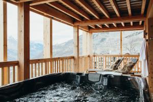 a tub in a room with a view of mountains at Duplex Isère by Lodji in Saint-Martin-de-Belleville