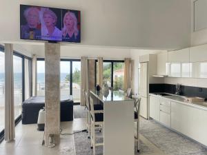 a kitchen with a flat screen tv on the wall at Apartments Plaza in Ulcinj
