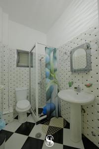 a bathroom with a toilet and a sink at Sala's Boutique Hotel in Sarandë