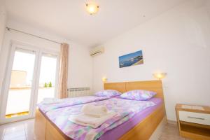 Postel nebo postele na pokoji v ubytování Apartments Cvito